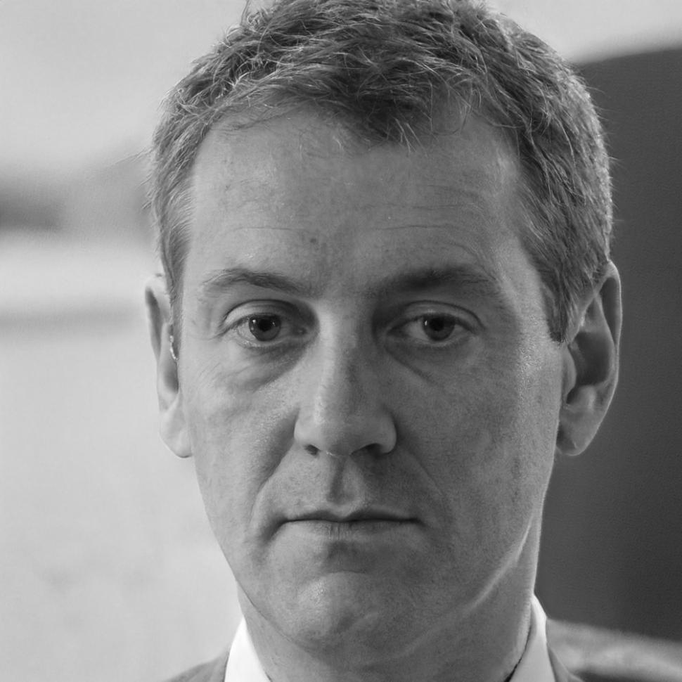 Professional headshot of economic modeling expert